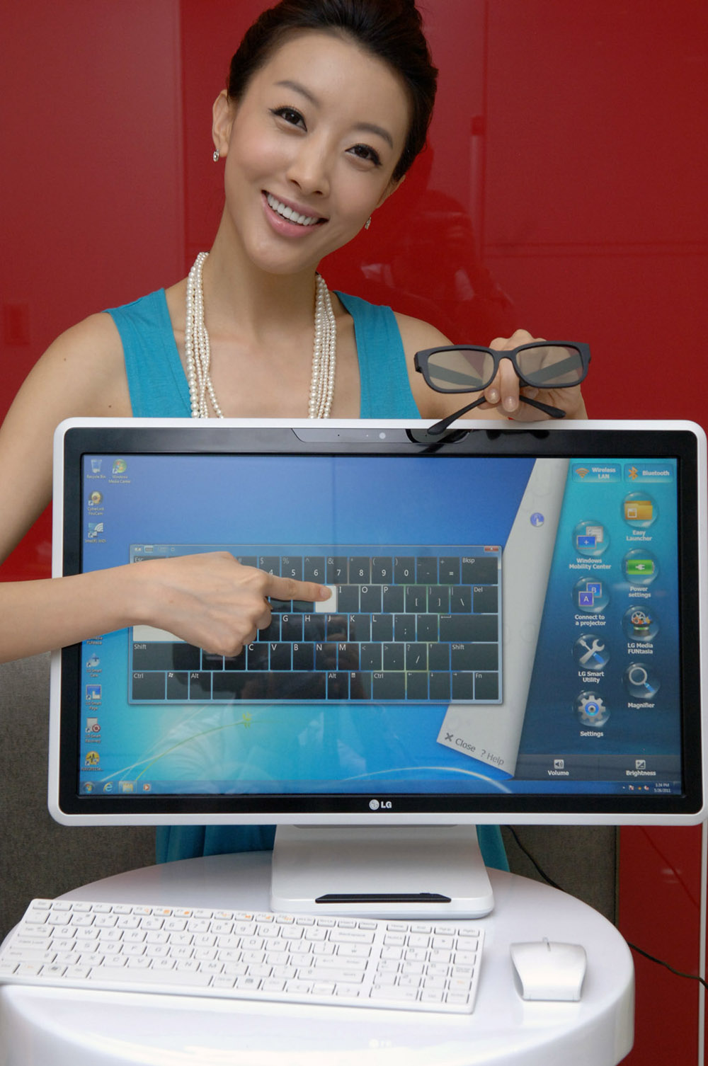 Marketing image of a model pointing at the touch screen of the LG ALL-IN-ONE PC