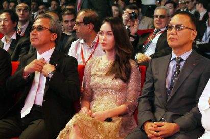 Kyung-hoon Byun, executive vice president of LG Electronics Home Entertainment Company, Megan Fox and K.W. Kim, president of LG Electronics, Middle East and Africa, sit together at Ferrari World in Abu Dhabi