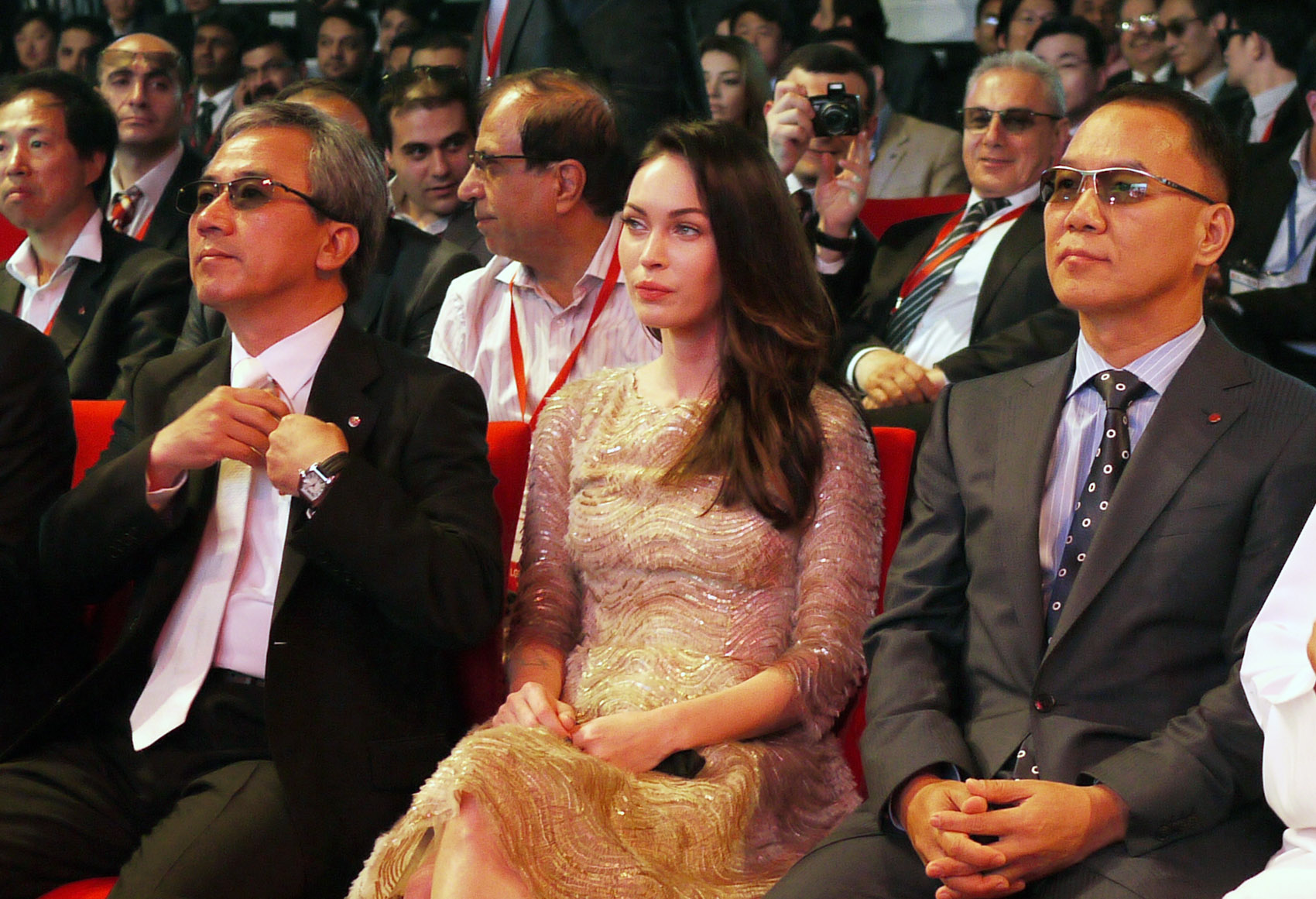 Kyung-hoon Byun, executive vice president of LG Electronics Home Entertainment Company, Megan Fox and K.W. Kim, president of LG Electronics, Middle East and Africa, sit together at Ferrari World in Abu Dhabi