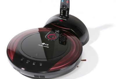 Top view of the LG HOM-BOT smart vacuum cleaning robot in its docking station with its remote-control