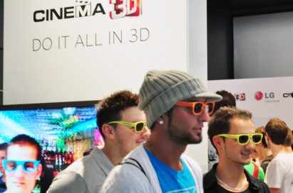 Three visitors wearing 3D glasses at the LG 3D Game Festival booth in Gamescom