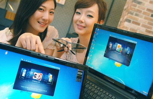 Two models present LG 3D notebooks while one of them holds 3D glasses.