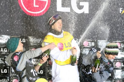 The players celebrate their winning with champagne in front of the LG stand