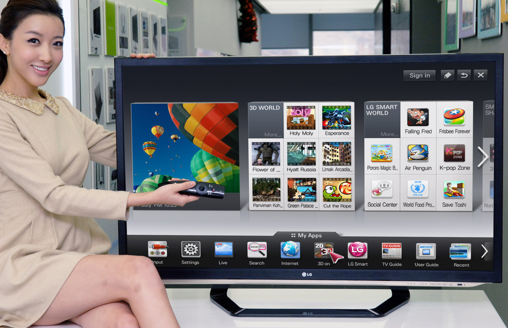 A model is demonstrating the newest Smart TV features with a 2012 LG CINEMA 3D Smart TV