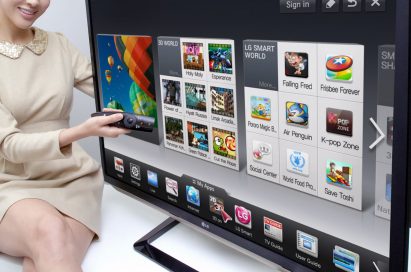 A model is demonstrating the newest Smart TV features with a 2012 LG CINEMA 3D Smart TV