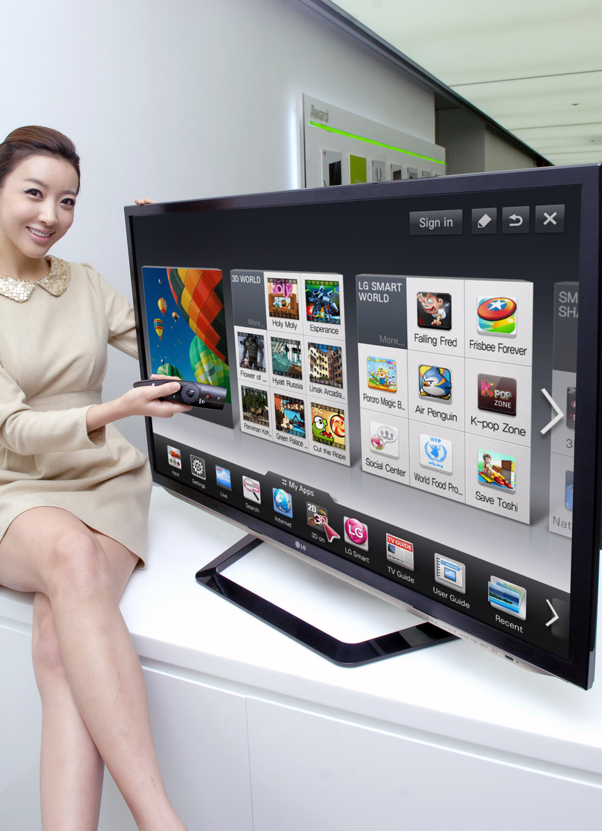A model is demonstrating the newest Smart TV features with a 2012 LG CINEMA 3D Smart TV