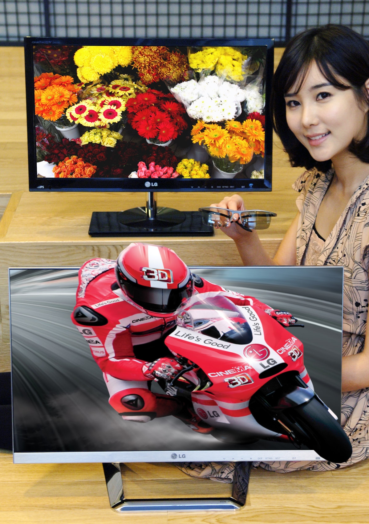 A model holds 3D glasses while presenting LG’s 2012 IPS monitors