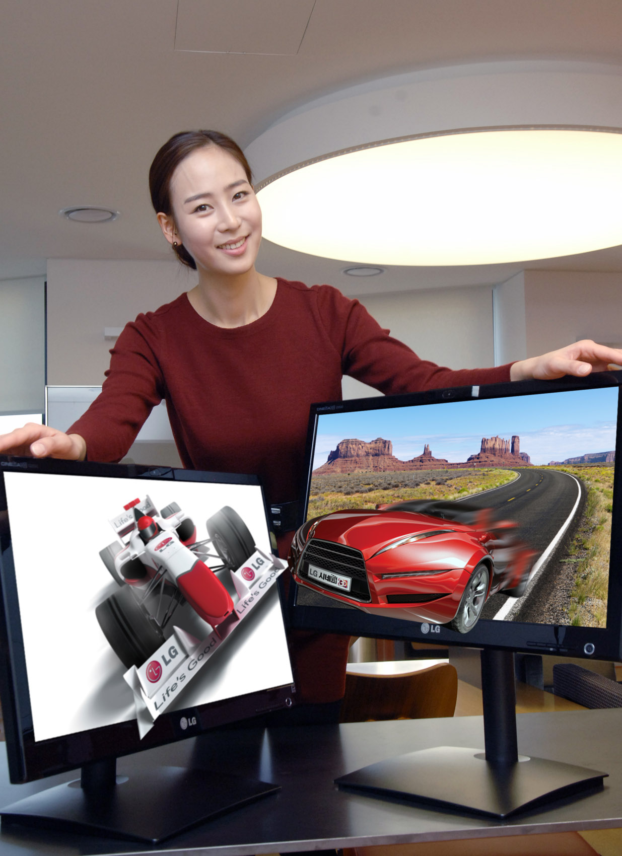 A model presents two of LG’s 25-inch Glasses-Free 3D monitors
