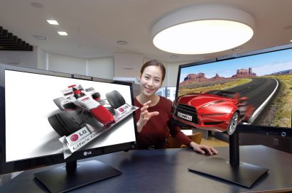 A model reaches out to grab 3D objects protruding out of LG’s 25-inch Glasses-Free 3D monitors