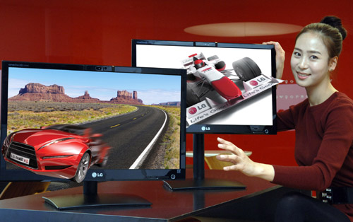 A model presents two of LG’s 25-inch Glasses-Free 3D monitors.