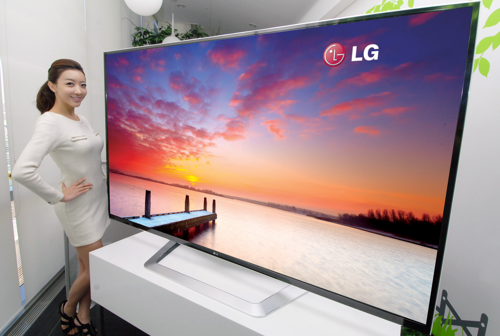 A model poses next to the world’s largest 84-inch 3D Ultra Definition TV