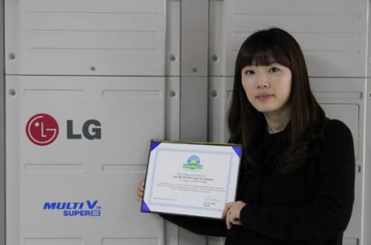 A close shot of a woman holding up LG MULTI V III’s carbon-free certification letter in front of the air conditioner appliance.