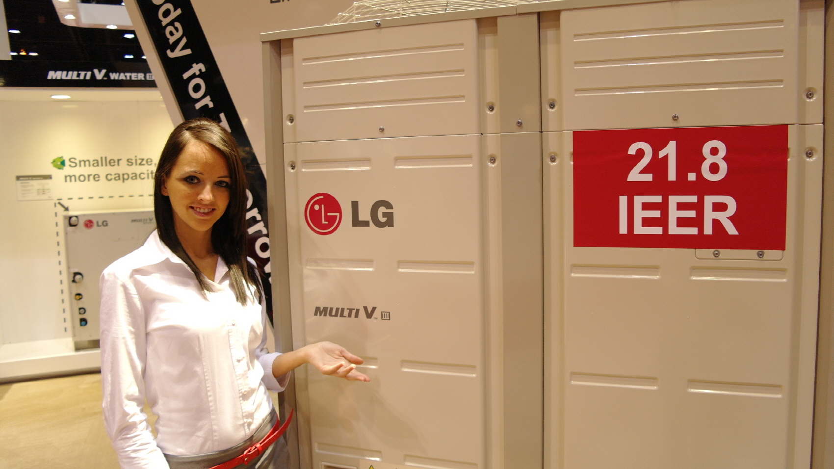 A woman posing in front of the LG Multi V III air conditioner