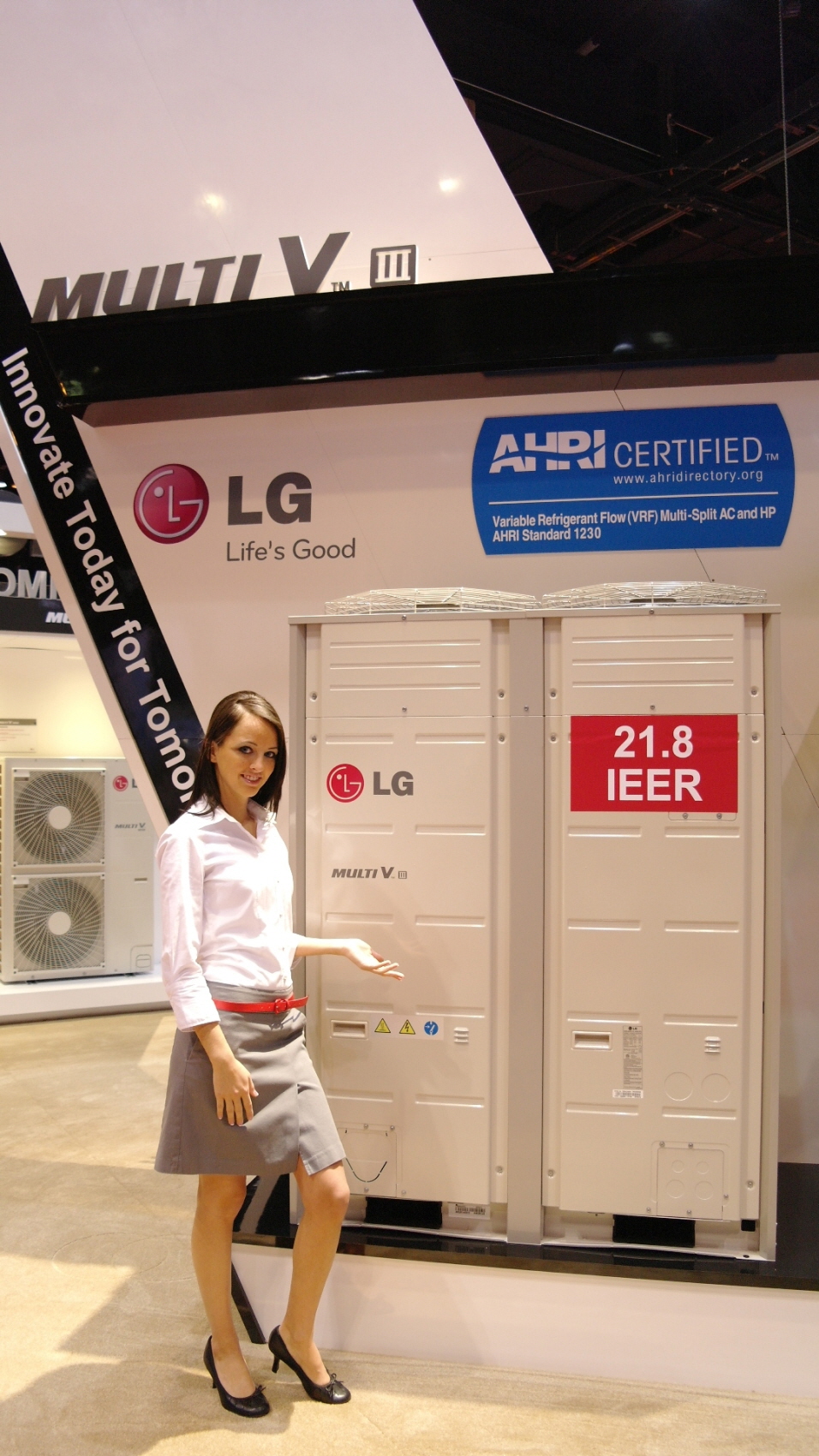 Another view of a woman posing in front of the LG Multi V III air conditioner