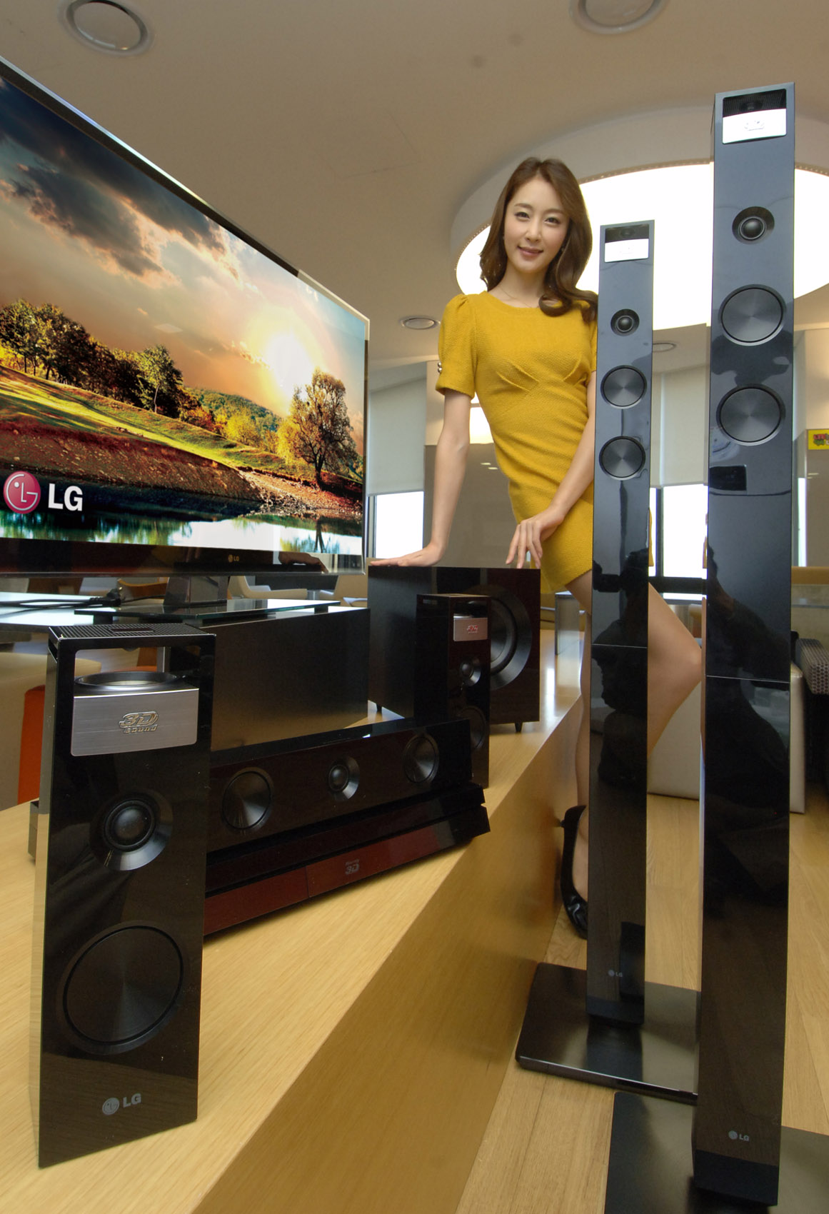 A model poses with LG 3D SOUND HTS and the LG CINEMA 3D Smart TV
