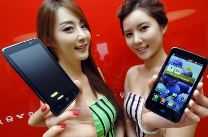 Two female models hold LG Optimus LTE and show its front views