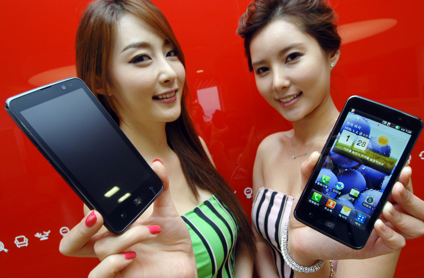 Two female models hold LG Optimus LTE and show its front views