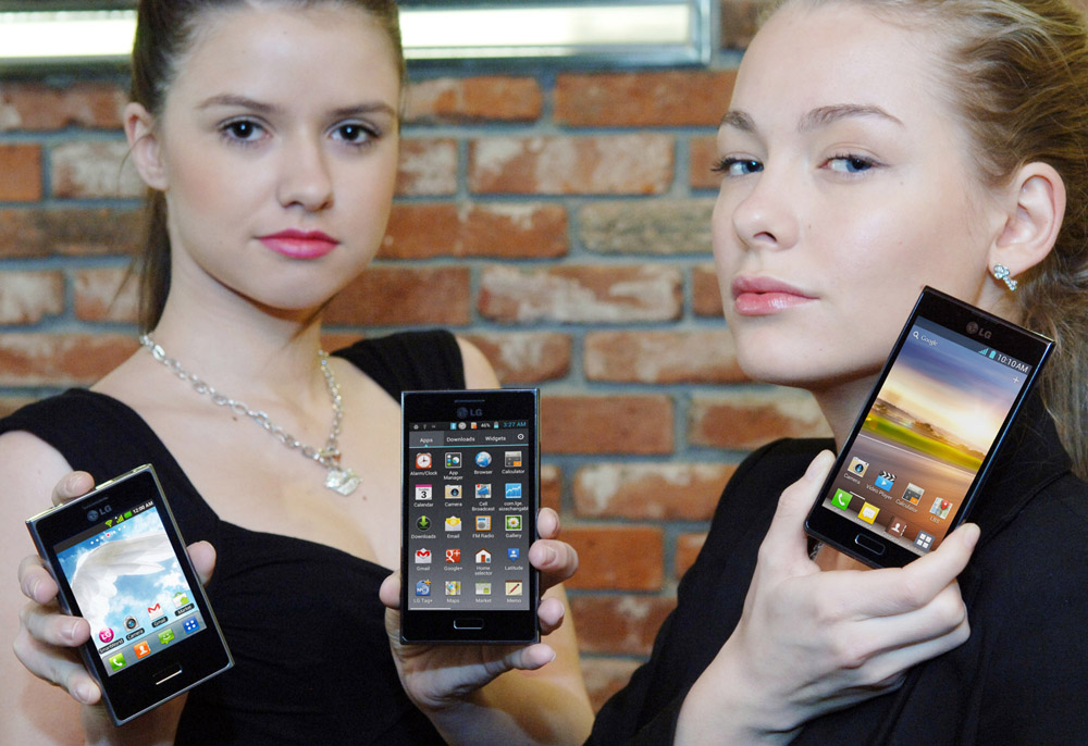 Two female models hold up LG's mobile phones which were designed under the L Design strategy.