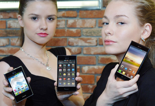 Two female models hold LG Optimus L3, LG Optimus L5 and LG Optimus L7 and show its front views