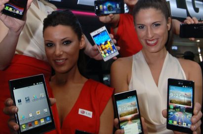 4 female models hold LG Optimus Vu:, LG Optimus 4X HD, LG Optimus 3D Max and LG Optimus L7 and show its front and rear views at LG Booth