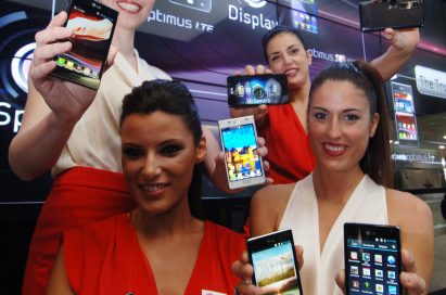 4 female models hold LG Optimus Vu:, LG Optimus 4X HD, LG Optimus 3D Max and LG Optimus L7 and show its front and rear views at LG Booth