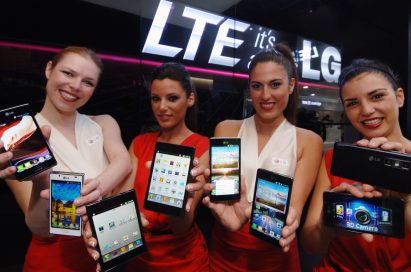 4 female models hold LG Optimus Vu:, LG Optimus 4X HD, LG Optimus 3D Max and LG Optimus L7 and show its front and rear views at LG Booth