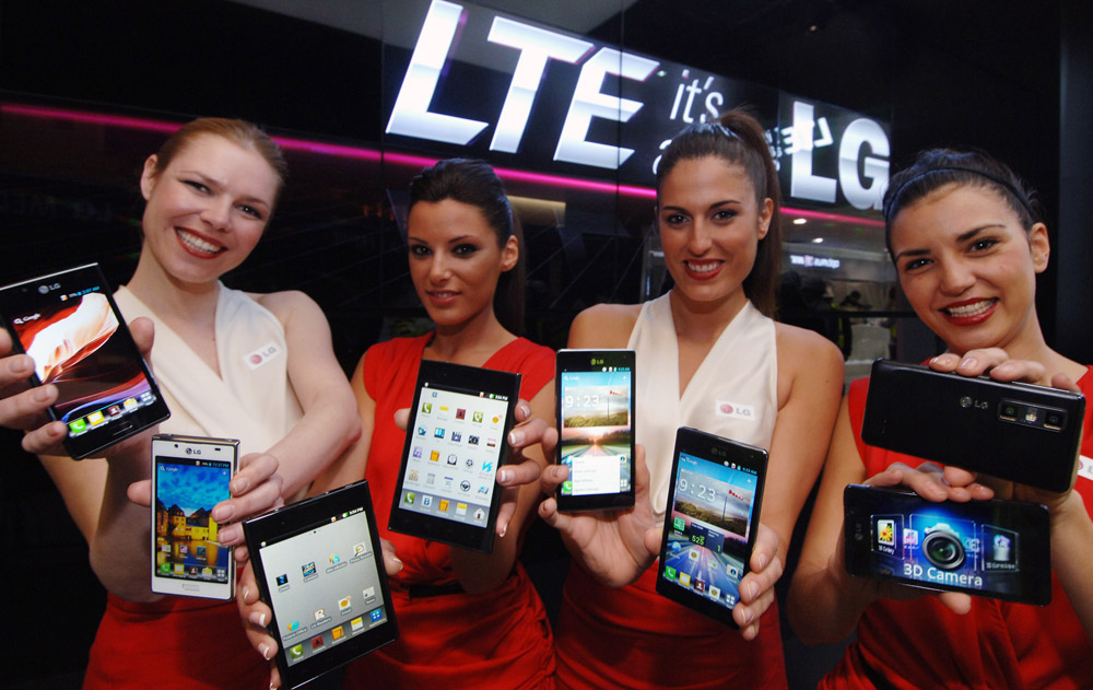 A different angle image of four female models holding eight LG LTE smartphones at MWC 2012