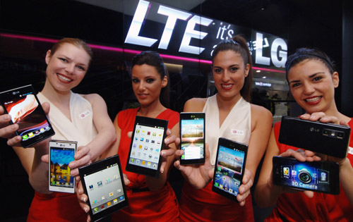 4 female models hold LG Optimus Vu:, LG Optimus 4X HD, LG Optimus 3D Max and LG Optimus L7 and show its front and rear views at LG Booth