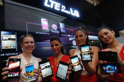 4 female models hold LG Optimus Vu:, LG Optimus 4X HD, LG Optimus 3D Max and LG Optimus L7 and show its front and rear views at LG Booth
