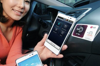 A female model holds two LG Optimus LTE Tags and shows their front views inside a car