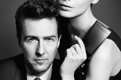 Daria Werbowy poses with Edward Norton while holding up the PRADA phone by LG 3.0 with its front showing