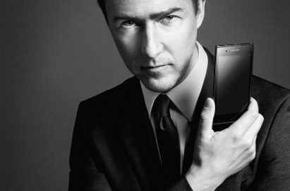 American actor Edward Norton holds up the PRADA phone by LG 3.0 with its front showing