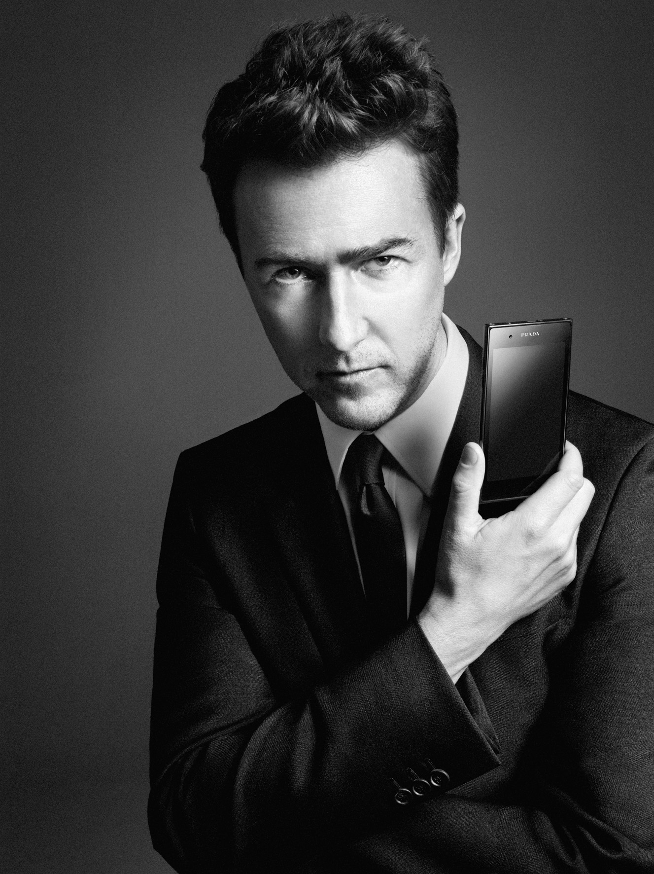 American actor Edward Norton holds up the PRADA phone by LG 3.0 with its front showing