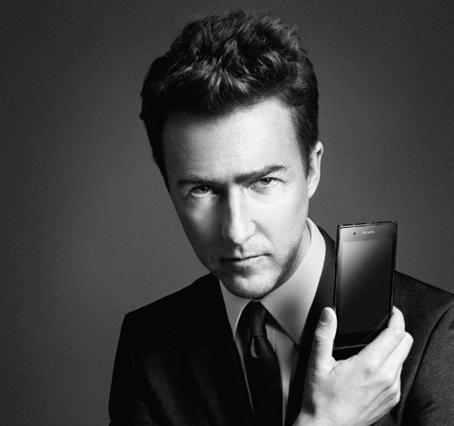 American actor Edward Norton holds up the PRADA phone by LG 3.0 with its front showing