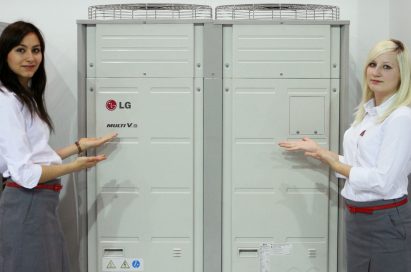 Two models posing next to LG’s Multi V III