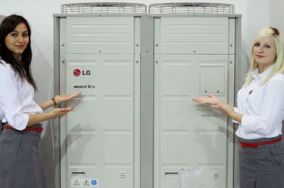 Two female models pose next to LG’s MULTI V III HEAT PUMP at MCE 2012.