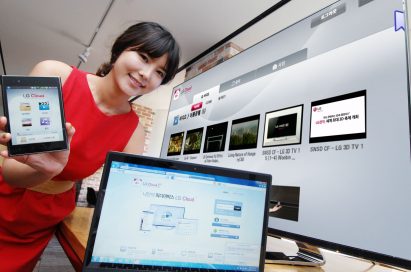 A model introduces the LG Cloud service which is compatible with TVs, mobile devices and PCs while standing up