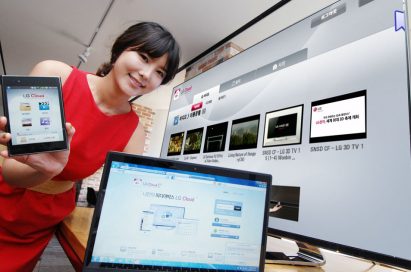 Another view of a female model holding up a phone displaying LG Cloud, the company's multimedia cloud platform on the screen while LG's XNote mirrors the phone’s screen