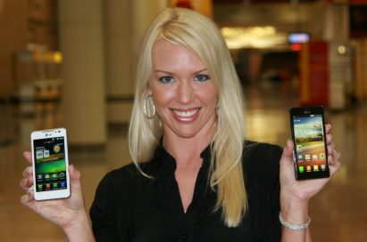 A female model holds white and black LG smartphones and shows its front views