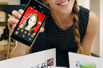 A female model holds a black LG Optimus 4X HD behind the logos of LG Optimus 4X HD and SiO technology, while a front view of the white LG Optimus 4X HD stands at the front