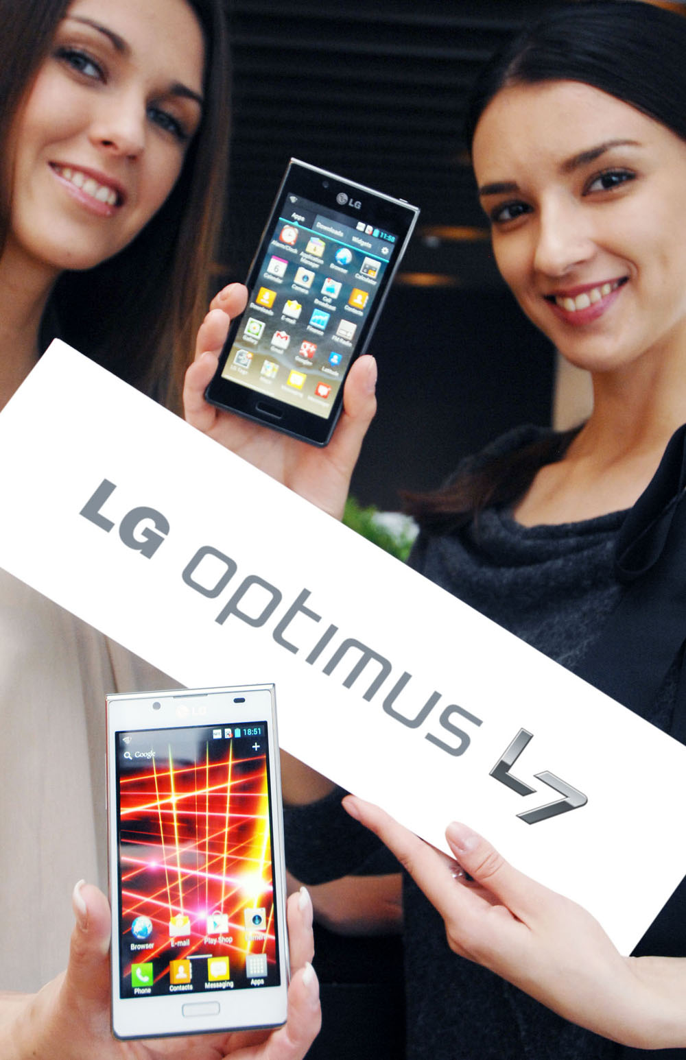 Another image of two female models holding the LG OPTIMUS L7 smartphone and its brand name panel at the launch event