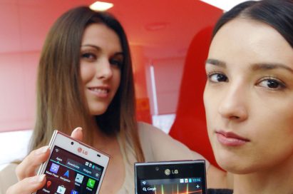 A third view of a model holding the white LG Optimus L7 while another holds the LG Optimus L7 and the LG Optimus L7 logo