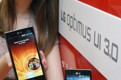 A female model holds two LG smartphones and shows a new Optimus UI 3.0