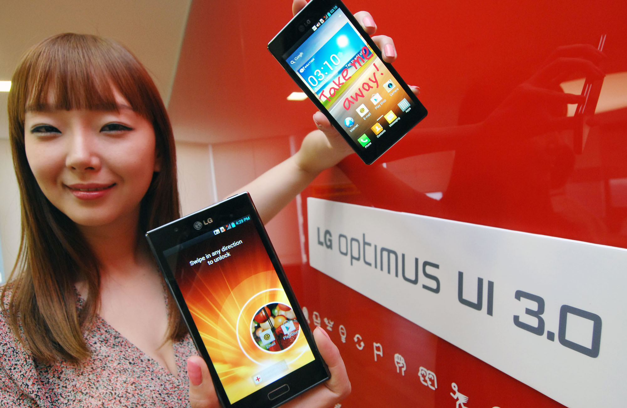 A female model holds two LG smartphones and shows a new Optimus UI 3.0