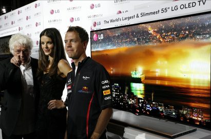 Film director Jean-Jacques Annaud, model Gemma Sanderson and F1 Champion Sebastian Vettel pose in front of LG’s new 55-inch OLED TV in Monaco