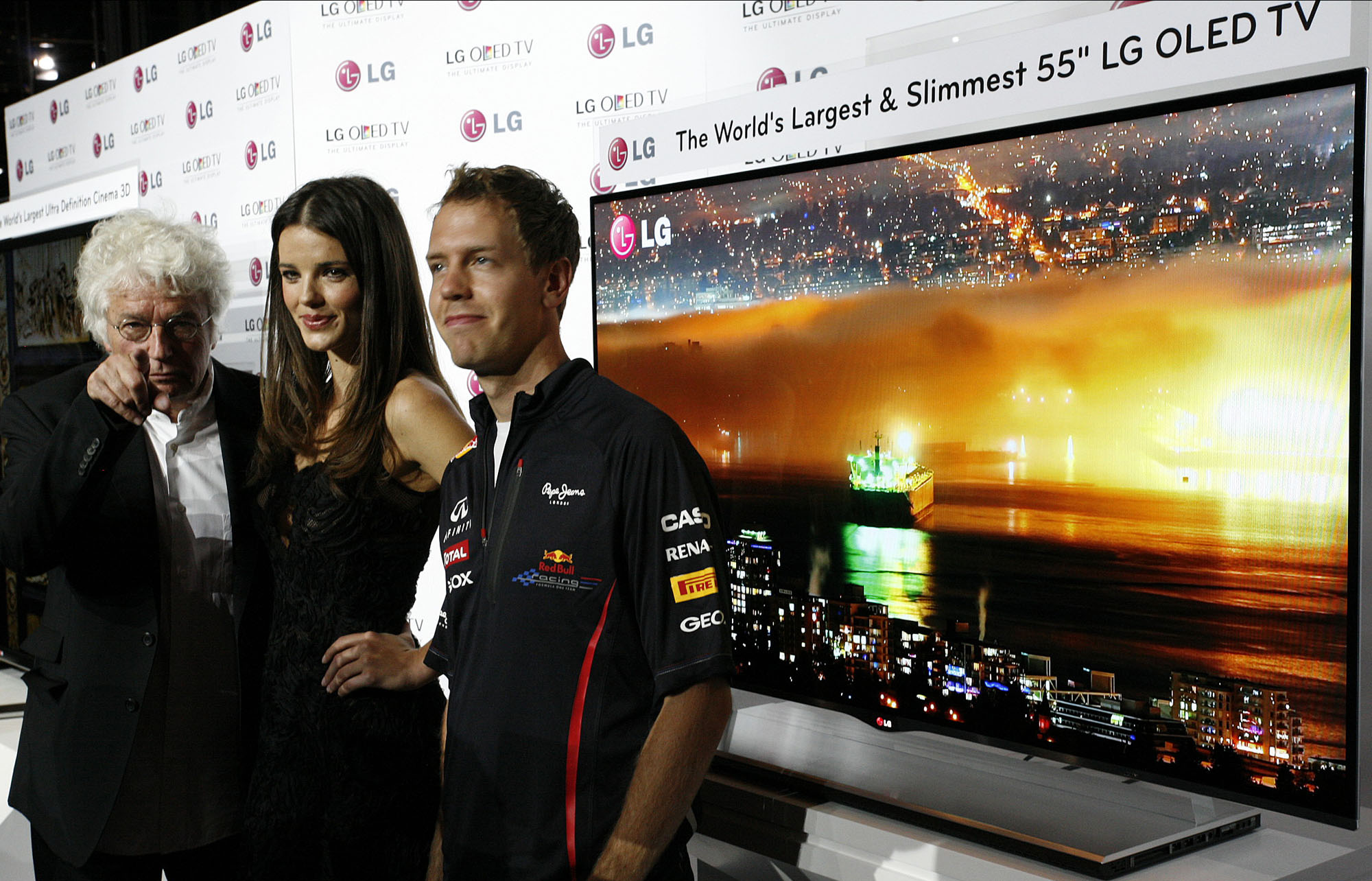 Film director Jean-Jacques Annaud, model Gemma Sanderson and F1 Champion Sebastian Vettel pose in front of LG’s new 55-inch OLED TV in Monaco