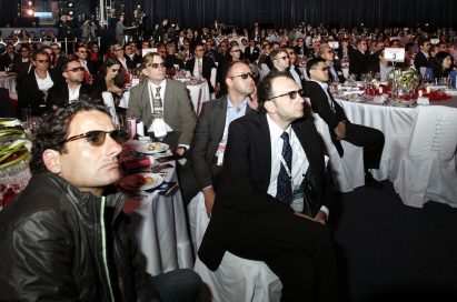 Attendees wearing 3D glasses to watch a 3D video on LG’s new OLED TVs at Salle des Etoiles in Monaco.