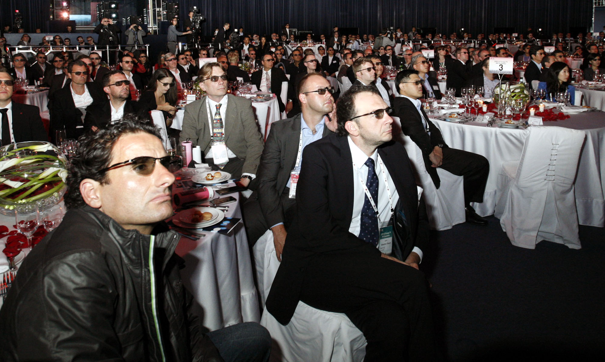 Attendees wearing 3D glasses to watch a 3D video on LG’s new OLED TVs at Salle des Etoiles in Monaco.