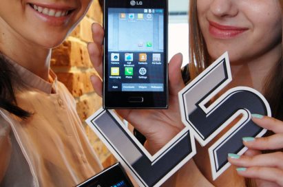 Close view of two women holding two LG OPTIMIUS L5s between them