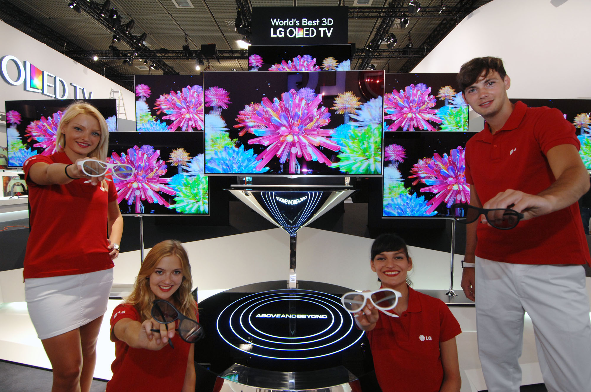 LG booth staff holding 3D glasses while presenting LG’s 3D OLED TVs at IFA 2012